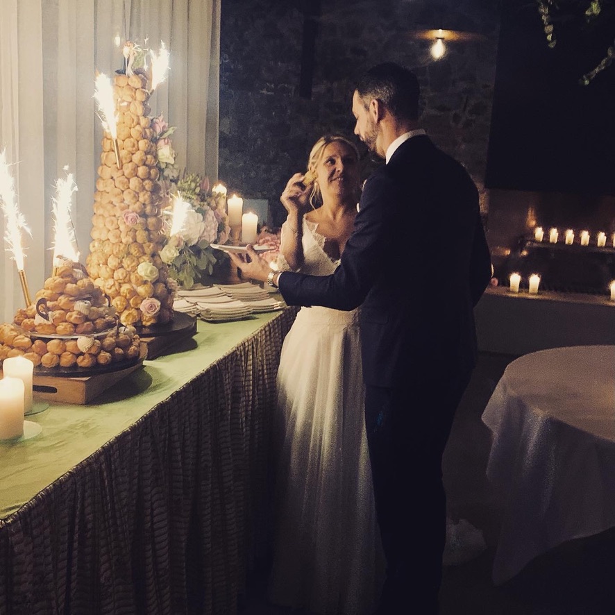 Mariés devant le gâteau et la table des desserts